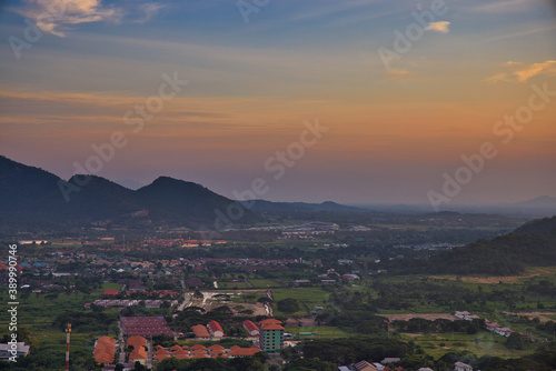 This unique photo shows the sunset in late October over the Thai seaside town called Hua Hin. you can see the houses and mountains very well.