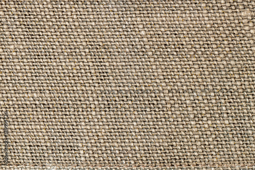 Natural organic sackcloth with lurex, texture closeup of burlap, canvas, pattern for background.