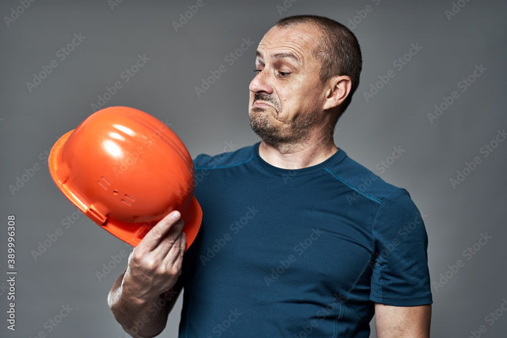 Engineer checking hardhat quality Engineer checking hardhat quality