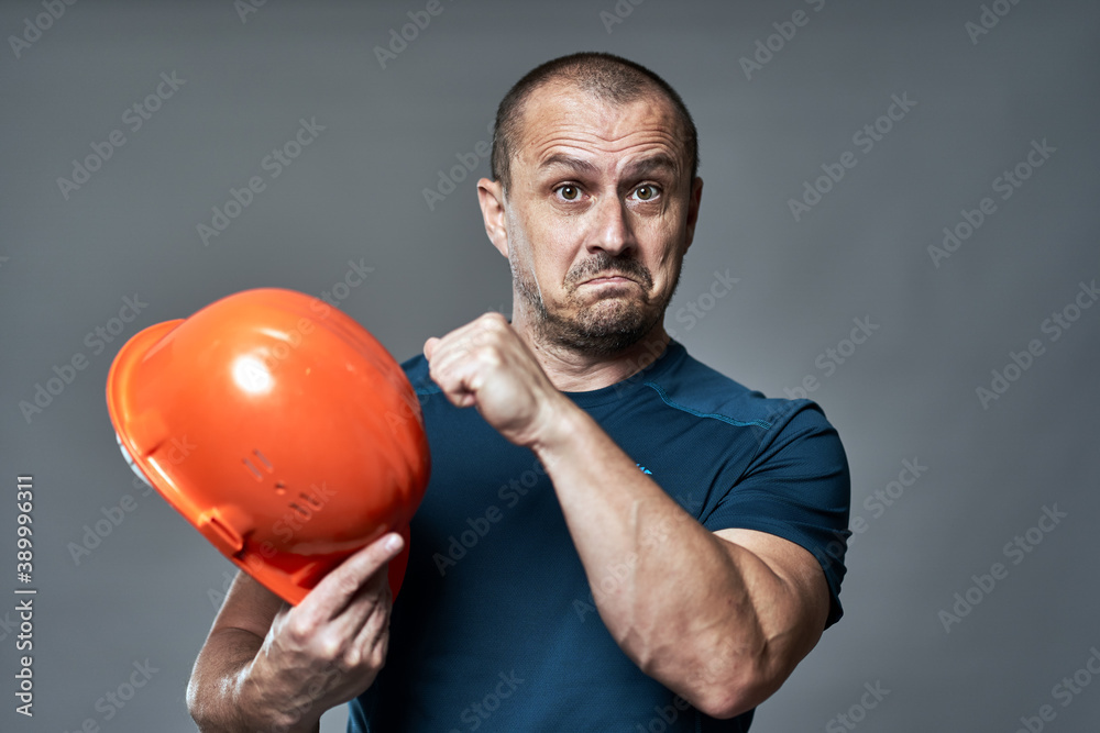 Engineer checking hardhat quality Engineer checking hardhat quality