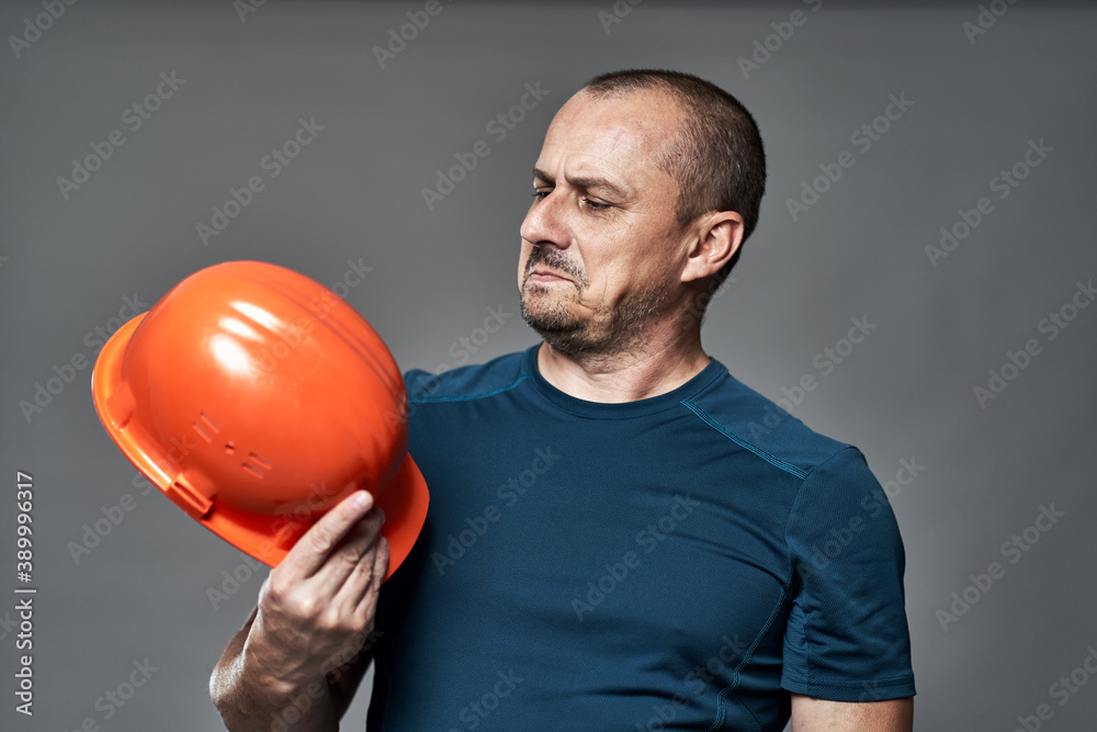 Engineer checking hardhat quality Engineer checking hardhat quality