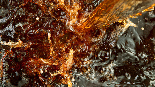 Close-up of ice tea, cola or beer, abstract top down beverage background