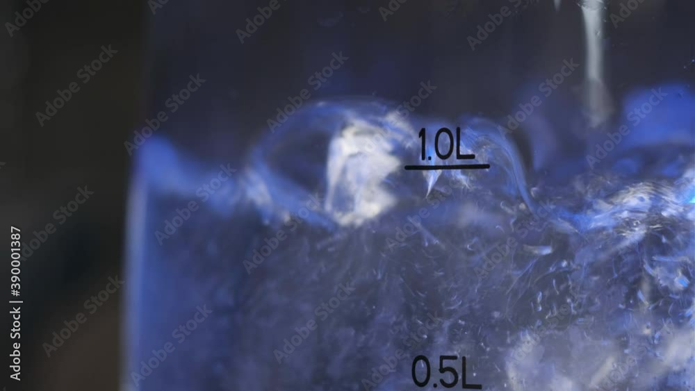 Close up footage of water boiling in pot. We see bubbles of boiling