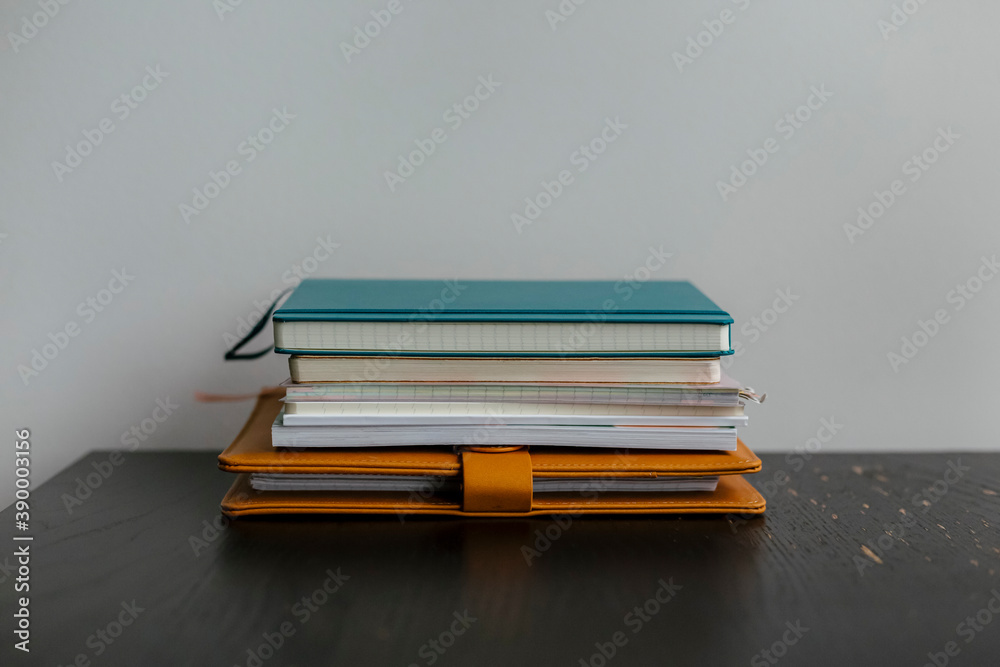 Stack of notebooks on desk Stack of notebooks on desk