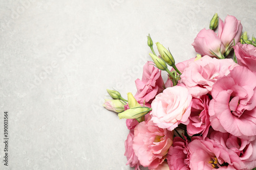 Fototapeta Naklejka Na Ścianę i Meble -  Beautiful bouquet of pink Eustoma flowers on light grey background, top view. Space for text