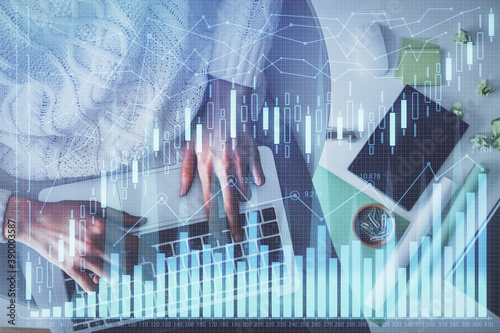 Multi exposure of woman hands working on computer and forex chart hologram drawing. Top View. Financial analysis concept.