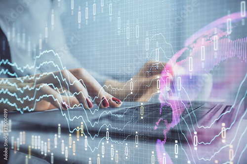 Multi exposure of woman hands typing on computer and financial graph hologram drawing. Stock market analysis concept. © peshkova