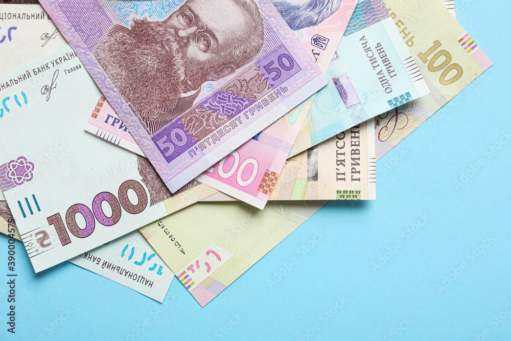Ukrainian money on light blue background, flat lay Ukrainian money on light blue background, flat lay