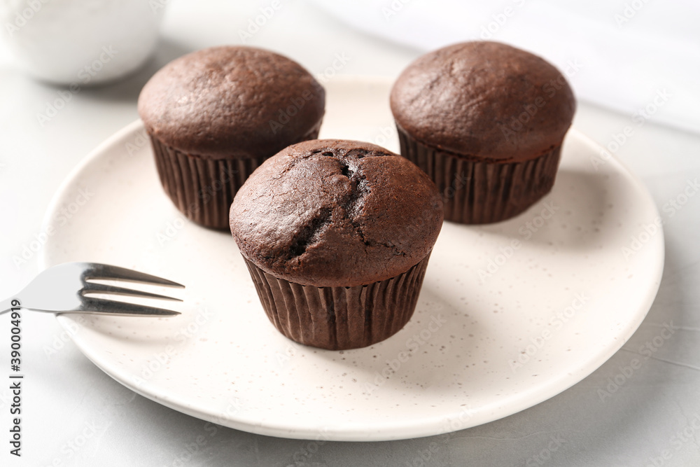 Delicious chocolate cupcakes on white table, closeup Delicious chocolate cupcakes on white table, closeup