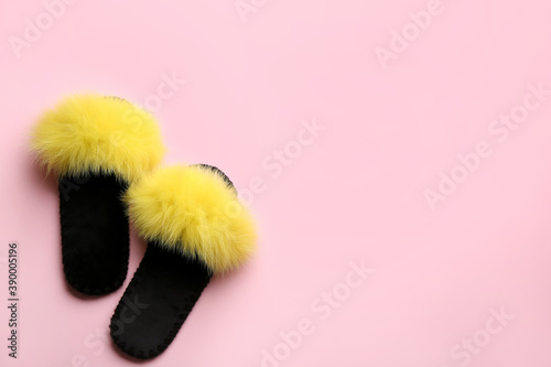 Pair of soft slippers on light pink background, flat lay. Space for text