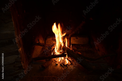 Warm fire and sparks in a fire-place from conflagrant wooden logs