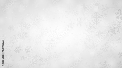 Christmas background of snowflakes of different shapes, sizes and transparency in gray and white colors