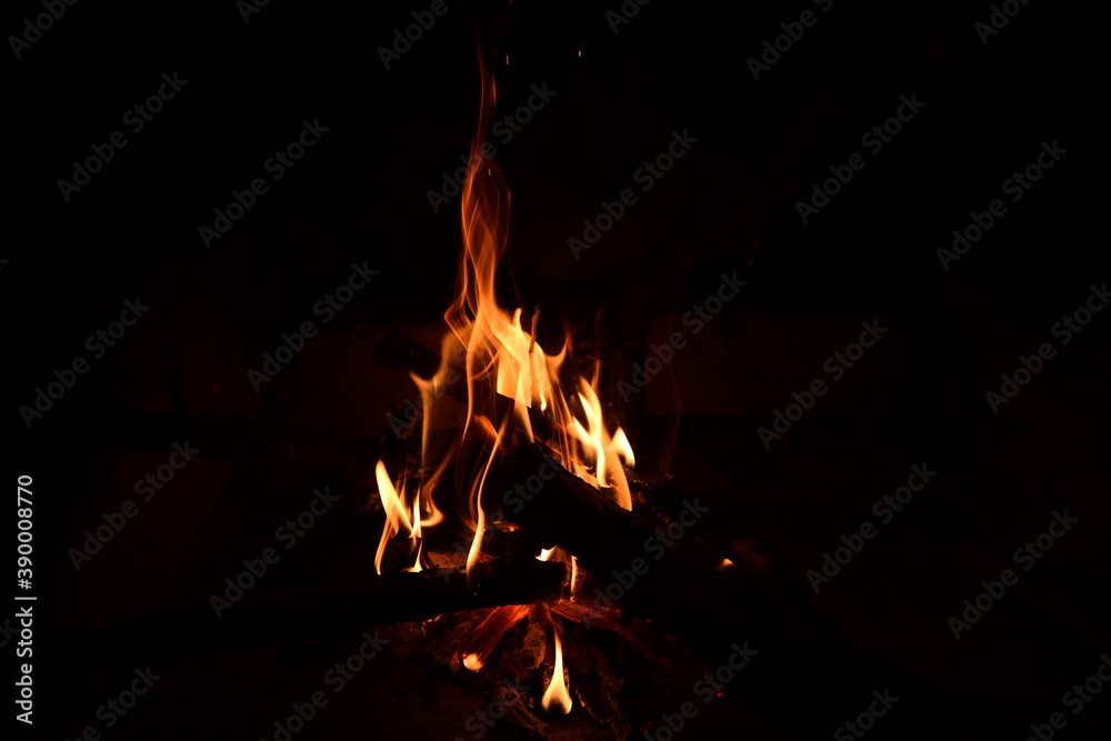 Warm fire and sparks in a fire-place from conflagrant wooden logs Warm fire and sparks in a fire-place from conflagrant wooden logs