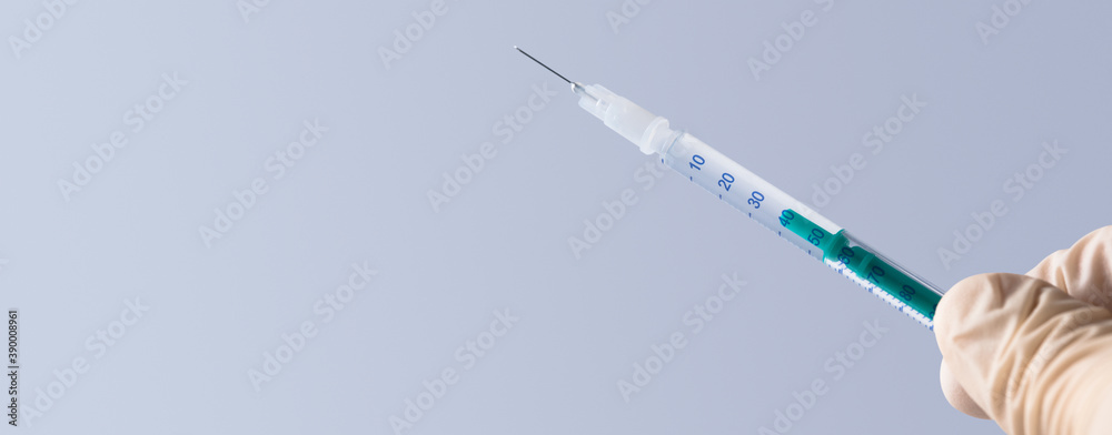 Doctor holding a syringe with vaccine against corona virus. Doctor holding a syringe with vaccine against corona virus.