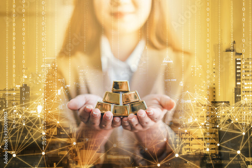 Fotografija business woman holding gold bar stack in her hand