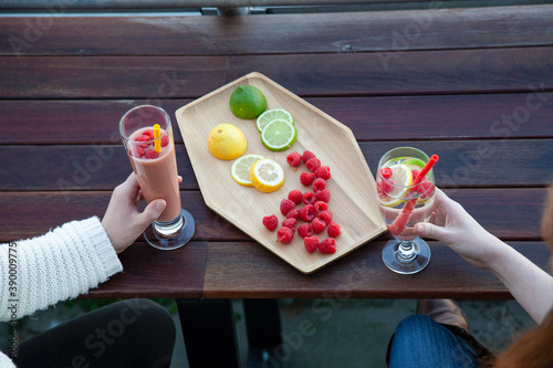An outdoor patio bar top with a fruit platter, and glass drinks with food-grade, silicone straws which are reusable and a plastic-alternative that is more sustainable