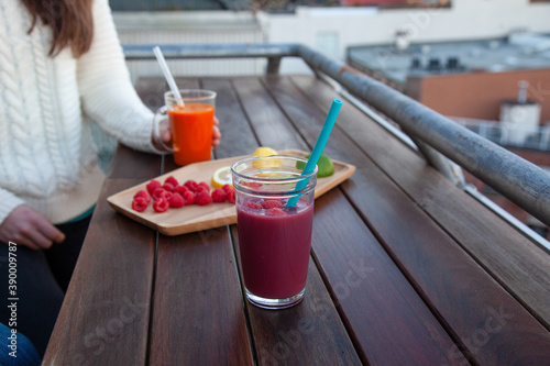 An outdoor patio bar top with a fruit platter, and glass drinks with food-grade, silicone straws which are reusable and a plastic-alternative that is more sustainable photo