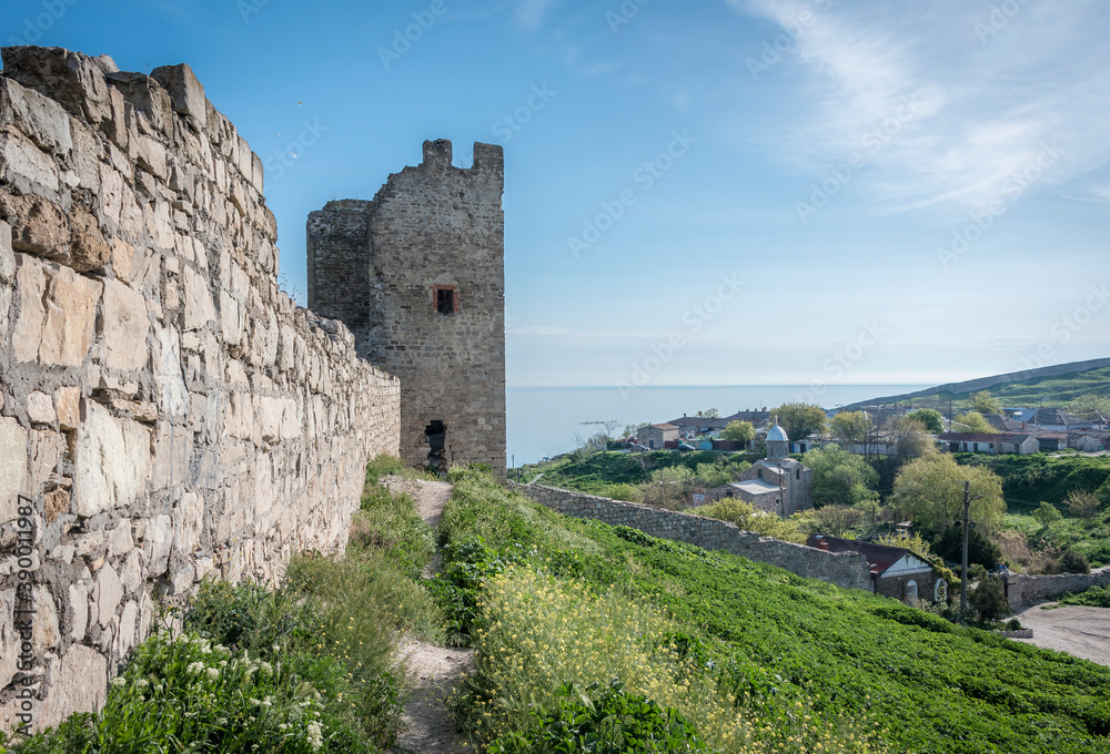 Obraz premium Medieval wall and tower of Genoese fortress in the city of Feodosia on the Crimean Peninsula, built by colonists from Genoa in the 14th century