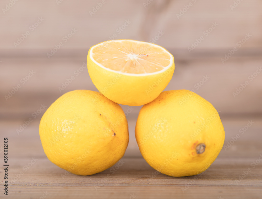 Two fresh lemons and half a cut lemon Two fresh lemons and half a cut lemon