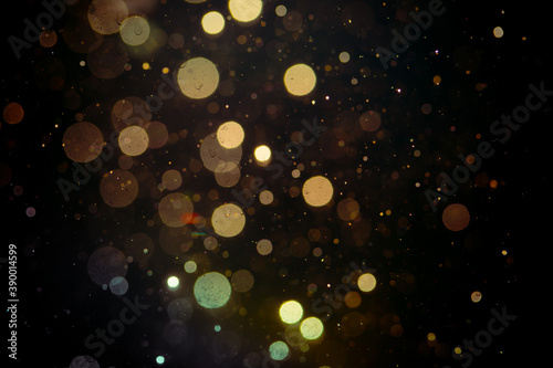 Gold bokeh from light in water with black background