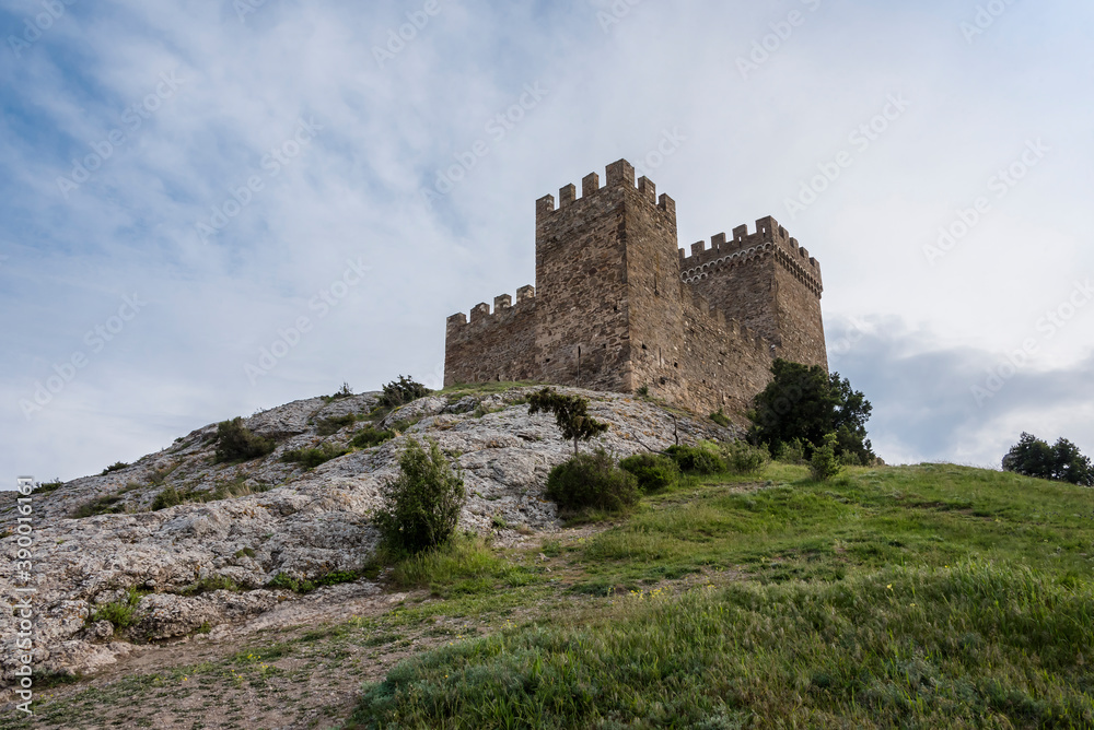Bottom view of the tower of Genoese fortress of the 14th century in the Sudak bay on the Peninsula of Crimea Bottom view of the tower of Genoese fortress of the 14th century in the Sudak bay on the Peninsula of Crimea