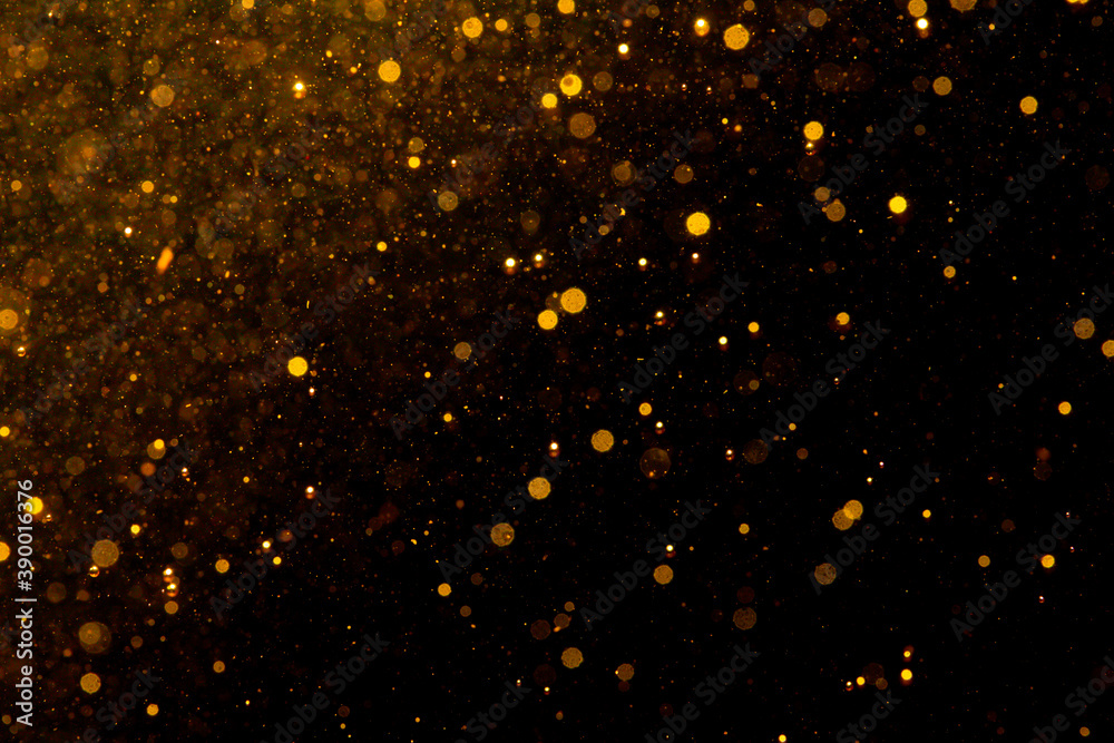 Gold bokeh of lights on black background