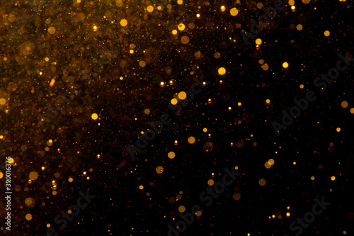 Gold bokeh of lights on black background