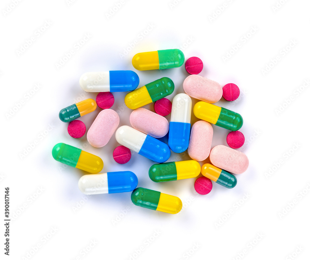 Piles of pills and capsule on white background. Top view