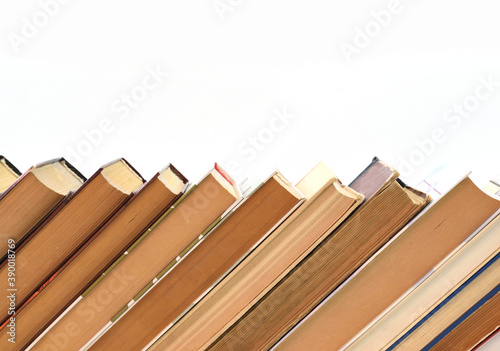 Stack of old books on white background, laid out obliquely
