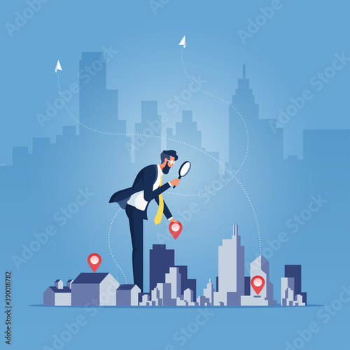 Real estate concept-Investment of real estate, Businessman holding magnifying glass and Building, building selection photo