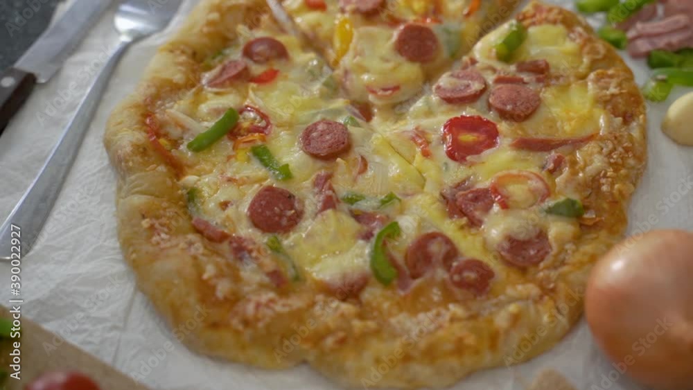 Italian pizza with tomato topped with melted cheese on a table Italian pizza with tomato topped with melted cheese on a table