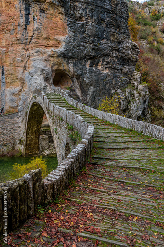 Kokori's old arch stone bridge (Noutsos) during fall season  situated on the river of Voidomatis in  Zagori, Epirus Greece. photo