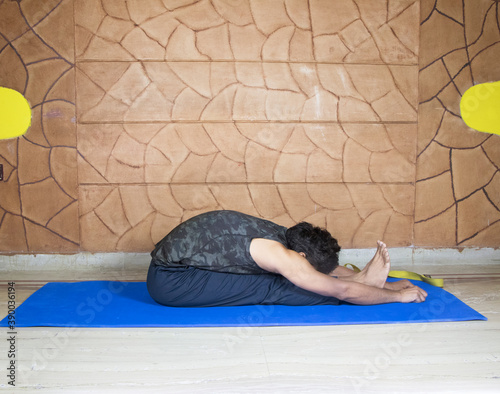 Male person in a yoga pose photo