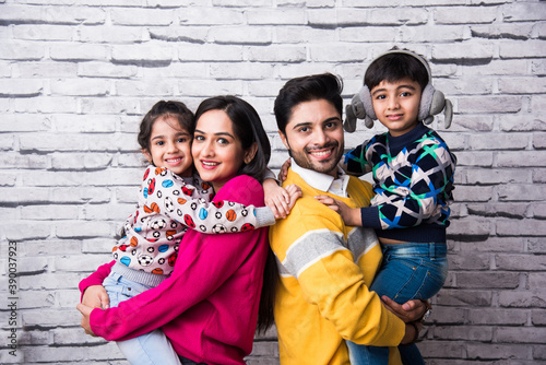 Konstfotografi Indian asian family of four wears colourful and warm sweaters or woolen or wooll
