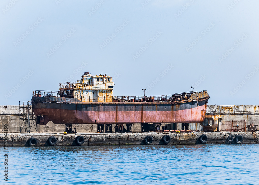 Old rusty ship-veterans on the last storage on the pier in Yalta, Crimea