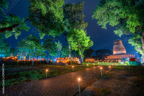 Beautiful scene light color The Loy Krathong festival 2020 at Pagoda in the Wat Aranyik is a historic temple  at night is a tourist Phitsanulok, Thailand. photo