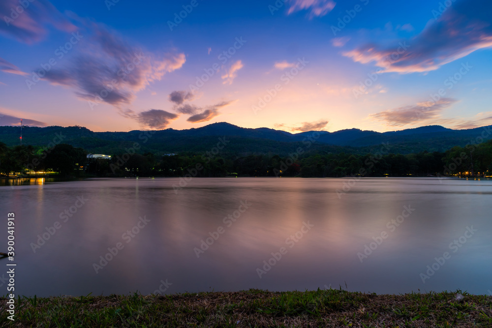 landscape lake views at Ang Kaew Chiang Mai University in nature forest Mountain views with evening blue dramatic sunset sky  background