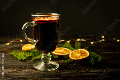 Mulled wine with cinnamon and an orange and fur-tree branches, a New Year's still-life
