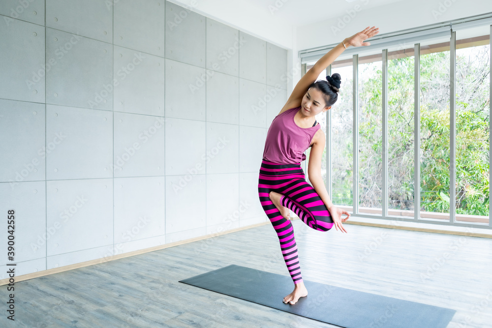 Asian women workout practicing yoga training put on pink clothes and practice meditation wellness lifestyle and health fitness concept in a gym,copy space Asian women workout practicing yoga training put on pink clothes and practice meditation wellness lifestyle and health fitness concept in a gym,copy space