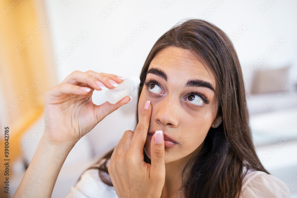 Photo of a woman using eye drop. Female dropping eye lubricant to treat dry eye or allergy. Sick girl treating eyeball irritation or inflammation sick woman suffering from irritated eye Photo of a woman using eye drop. Female dropping eye lubricant to treat dry eye or allergy. Sick girl treating eyeball irritation or inflammation sick woman suffering from irritated eye