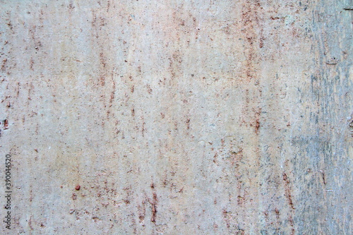 Retro concrete weathered wall old texture with rust leaks, with white, brown, gray and beige spots.. Design template. An old crumbling plaster. The background for text and design