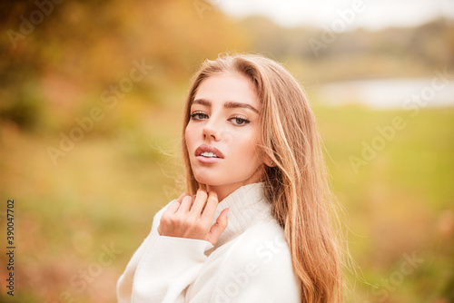 Beautiful elegant woman in autumn park, toned color.