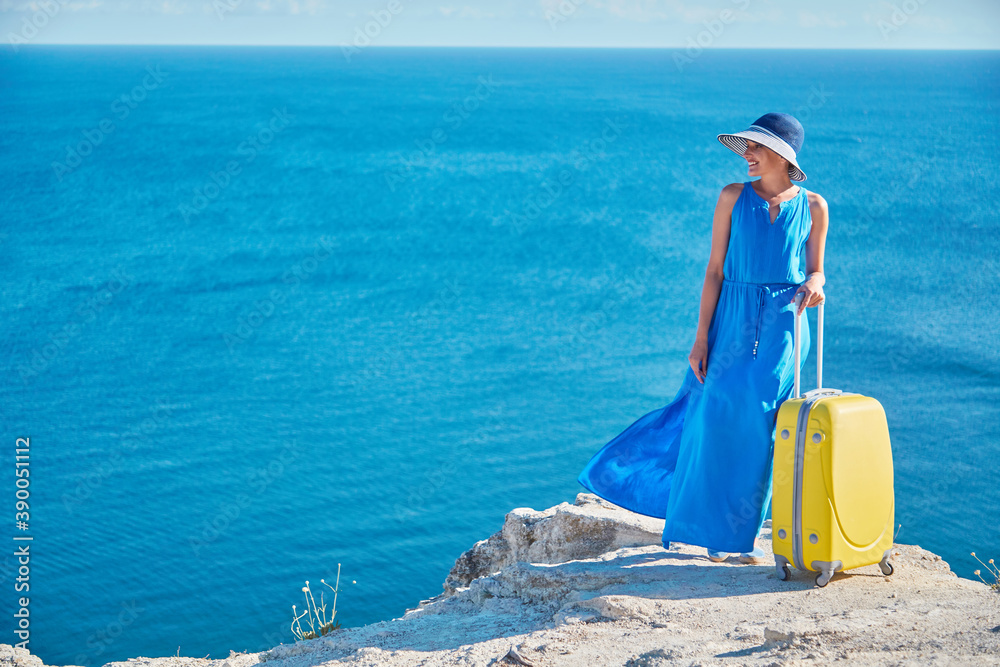 Vacation abroad and travelling idea, copy space. Happy woman posing on ocean background. Lady ready for summer holiday. Vacation abroad and travelling idea, copy space. Happy woman posing on ocean background. Lady ready for summer holiday.