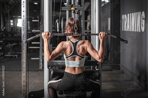 young fitness woman workout with exercise-machine in gym