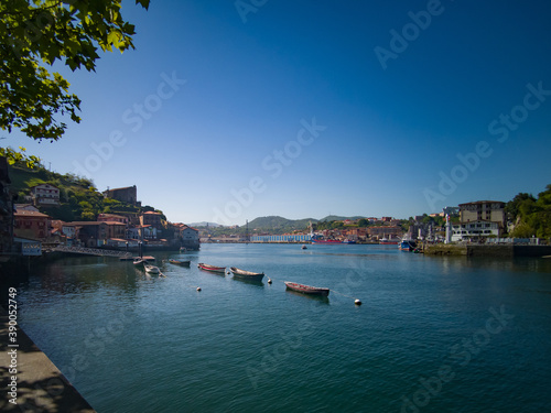 Boats by the pier in Pasai Donibane in the Northern coast of Spain photo