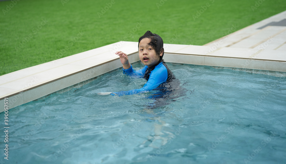 asian boy play in water pool