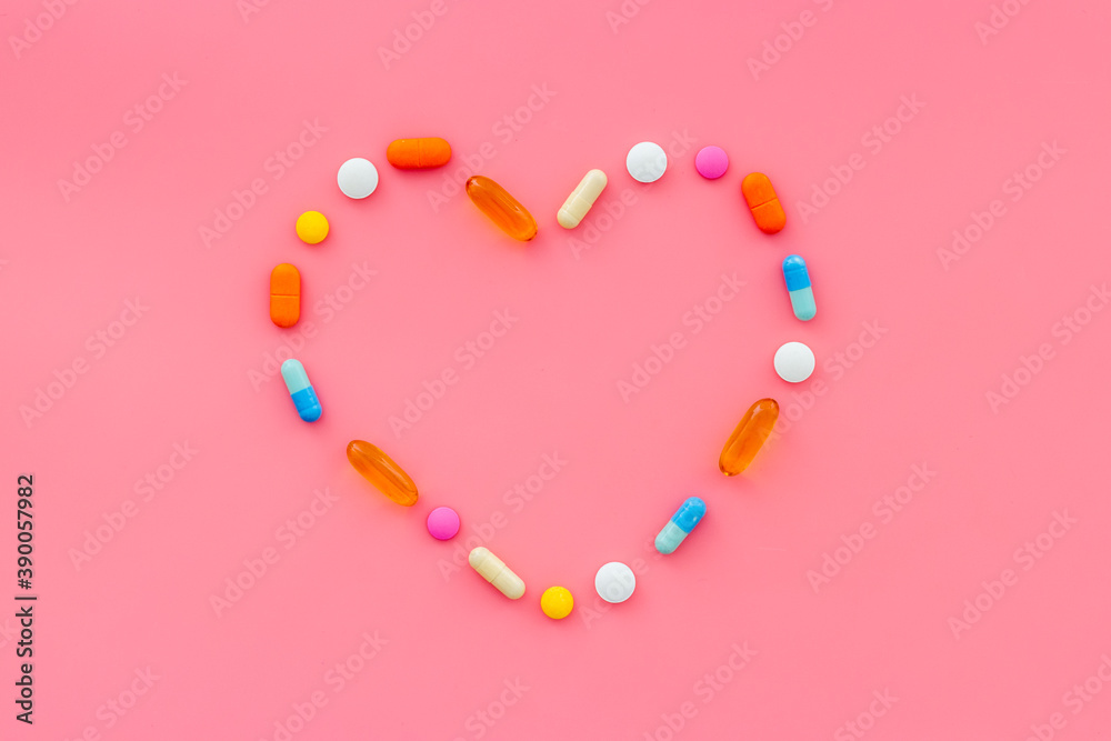 Heart disease. Medical capsules and pills, top view