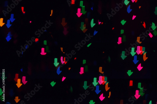 Bokeh lights background. Arrows bokeh defocused background. Holiday background. Garland. Defocused blinks. New Year. Bokeh retro style photo.