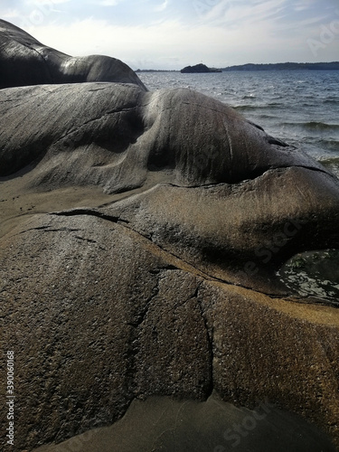 Vertical shot of the rocks on the Hvittensand beach in Ostre Halsen, Norway photo