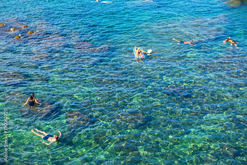 Tourists swimming in sea, top view. Beach in Sicily, Italy.